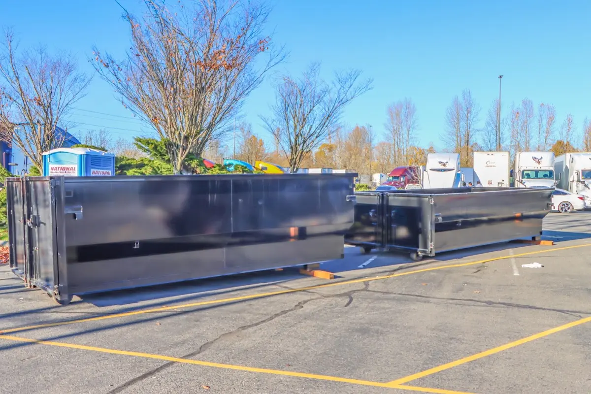 Professional dumpster rental service with roll-off container on residential driveway in Clarinda